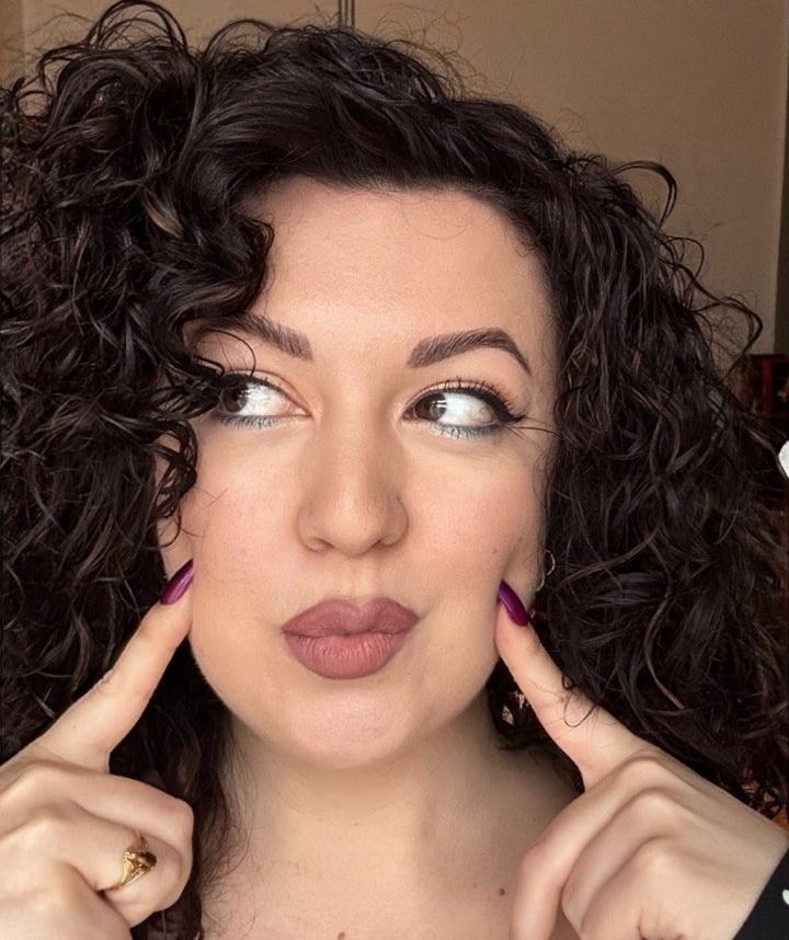 Portrait of the writer behind The Gorgeous Chaos making a playful face